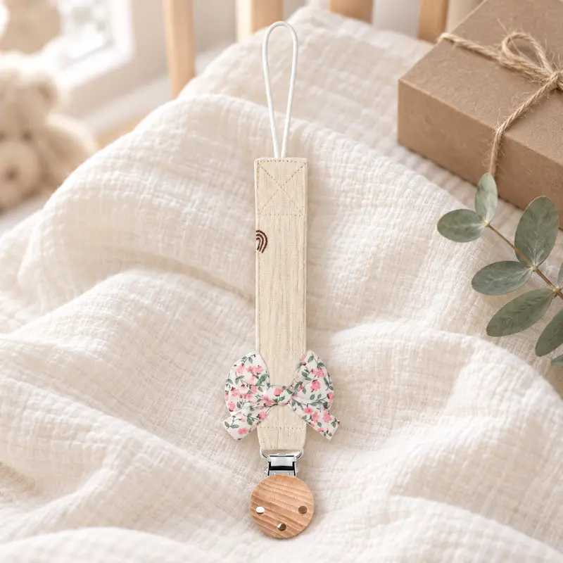 Attache-tétine bébé en tissu à nœud fleuri